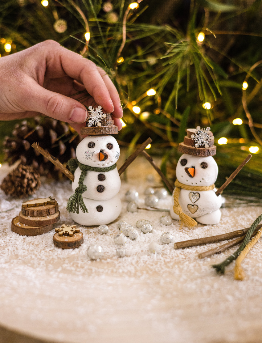 Poppy & Daisy DIY Clay Snowmen kit with box, clay, embellishments, and wooden pieces.