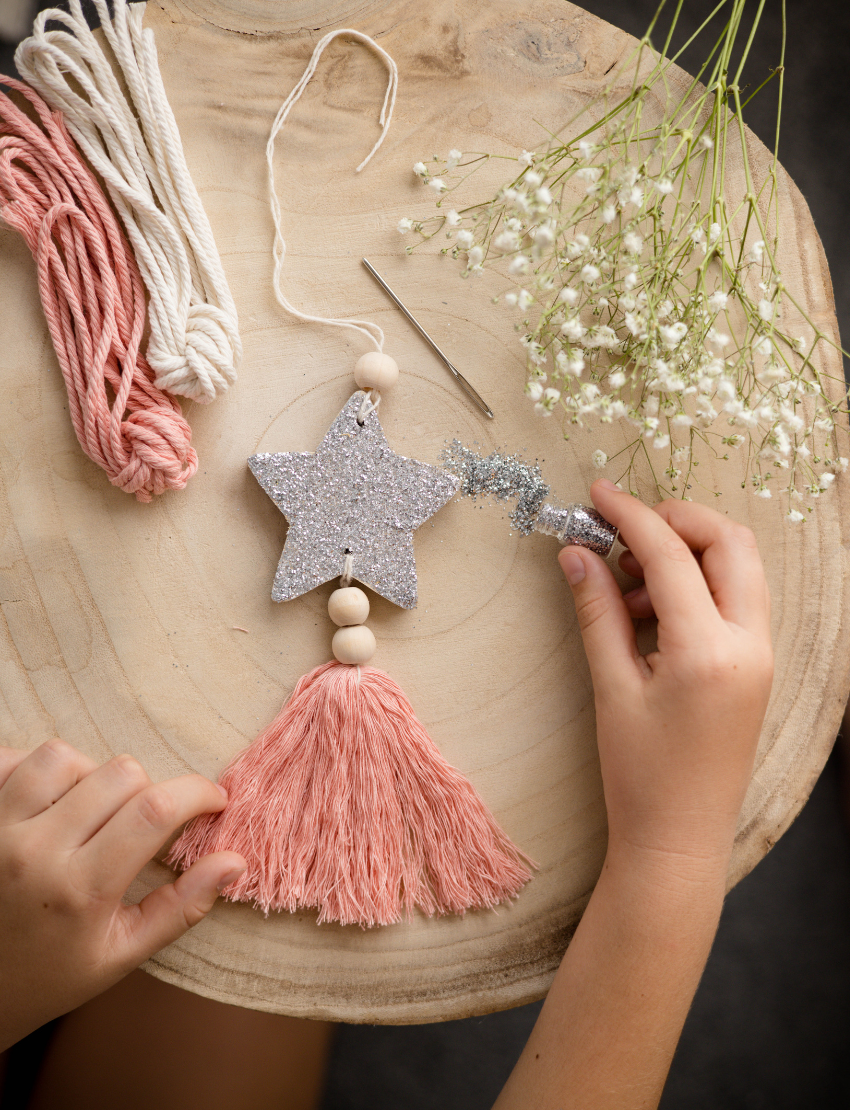 Poppy & Daisy 'Star Decoration' DIY kit: box, wooden star, glitter, brush, twine, and tassel.