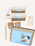 The Play Way 'Let's Create Fun Fossils' DIY kit components: sand, plaster, shells, and tools for unearthing ancient treasures.
