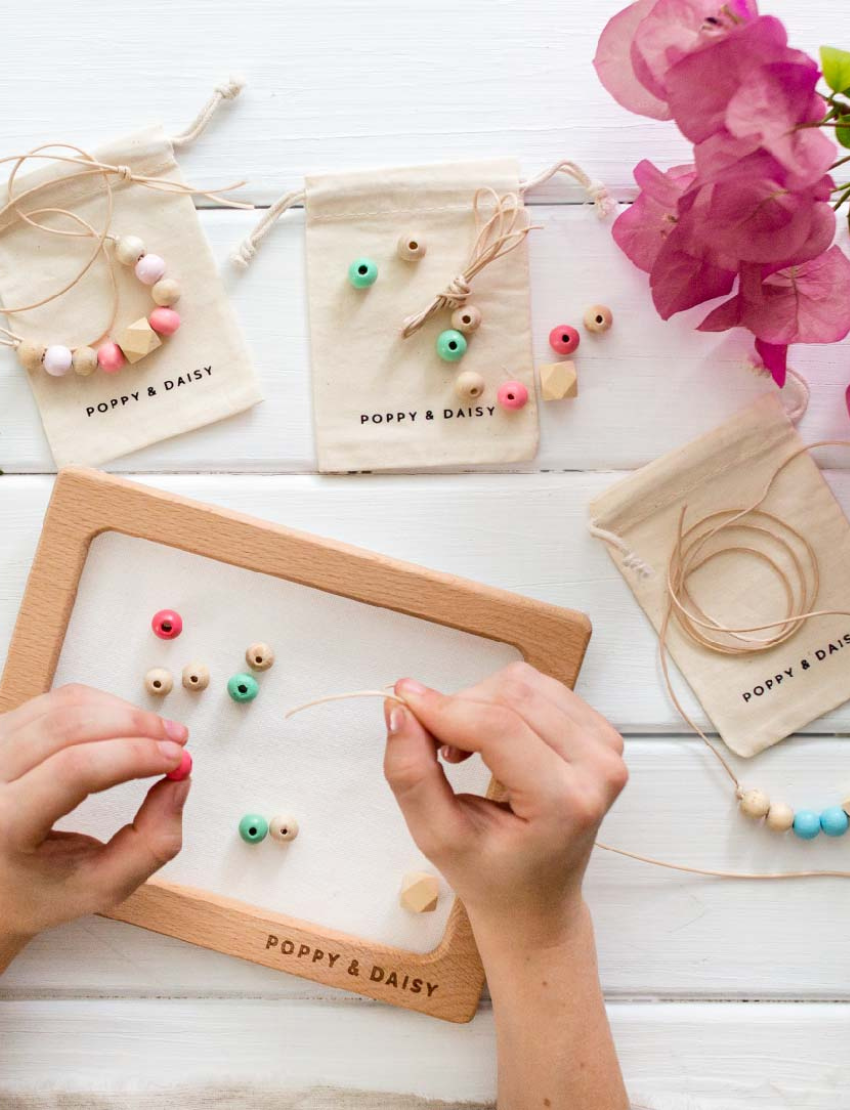 Poppy & Daisy 'Let's Create Friendship Necklaces' kit contents displayed, including box.