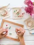 Beading activity with Poppy & Daisy friendship necklace kit, including beads and string.