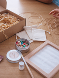 Poppy & Daisy 'Let's Create Friendship Necklaces' kit with beads, string, and tools.