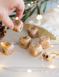 Close-up of Christmas story cubes with various icons, including Santa, tree, and sleigh.