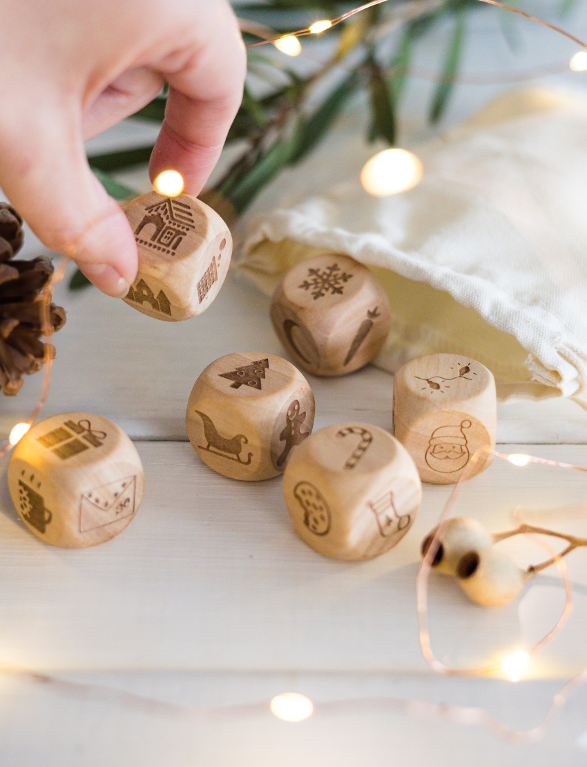 Close-up of Christmas story cubes with various icons, including Santa, tree, and sleigh.