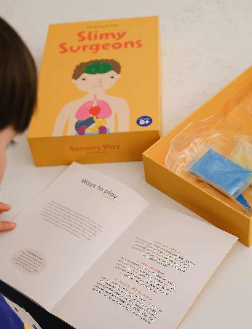 Child engaging with Slimy Surgeons instructions from Sensory Play Australia, learning human anatomy through interactive play.