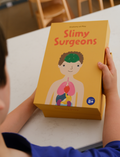 Child holding the Slimy Surgeons kit by Sensory Play Australia. A fun, hands-on sensory experience for anatomy learning (ages 8+).
