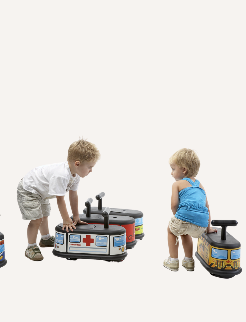 Children playing with Italstrike Ride On toy vehicles: ambulance, police, and fire truck.