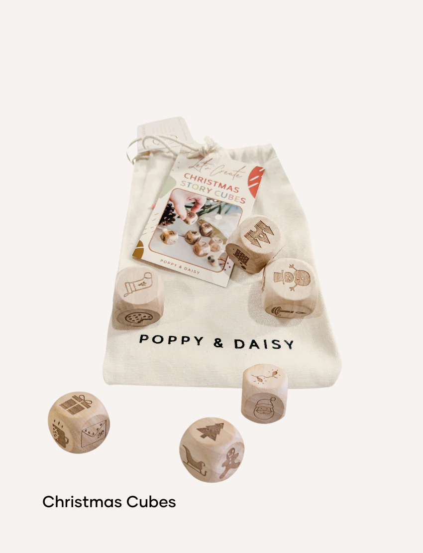 Poppy & Daisy Christmas Story Cubes with wooden cubes featuring holiday icons.