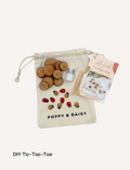 Poppy & Daisy DIY Tic-Tac-Toe kit with wooden game pieces, glue, and instructions.