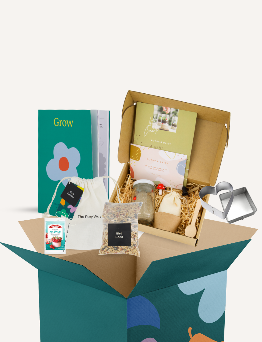 A photo of an open box displaying a variety of items from The Play Way's Gardening and Handwriting Kit, including a book titled "Grow," a drawstring bag, a pack of birdseed, a Melitta coffee pack, and crafting materials like a mushroom-shaped item and wooden spoon for fine motor development.