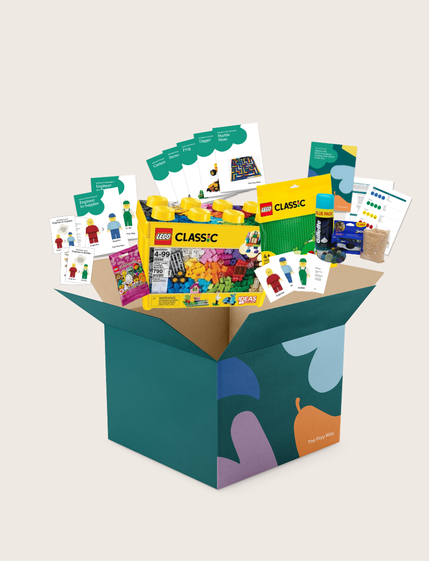 An open blue and green box from Therapy At Home's Build it with Bricks Foundation Program includes two LEGO Classic sets and colorful activity cards—ideal for supporting executive function skills in therapy sessions—displayed on a plain light background.