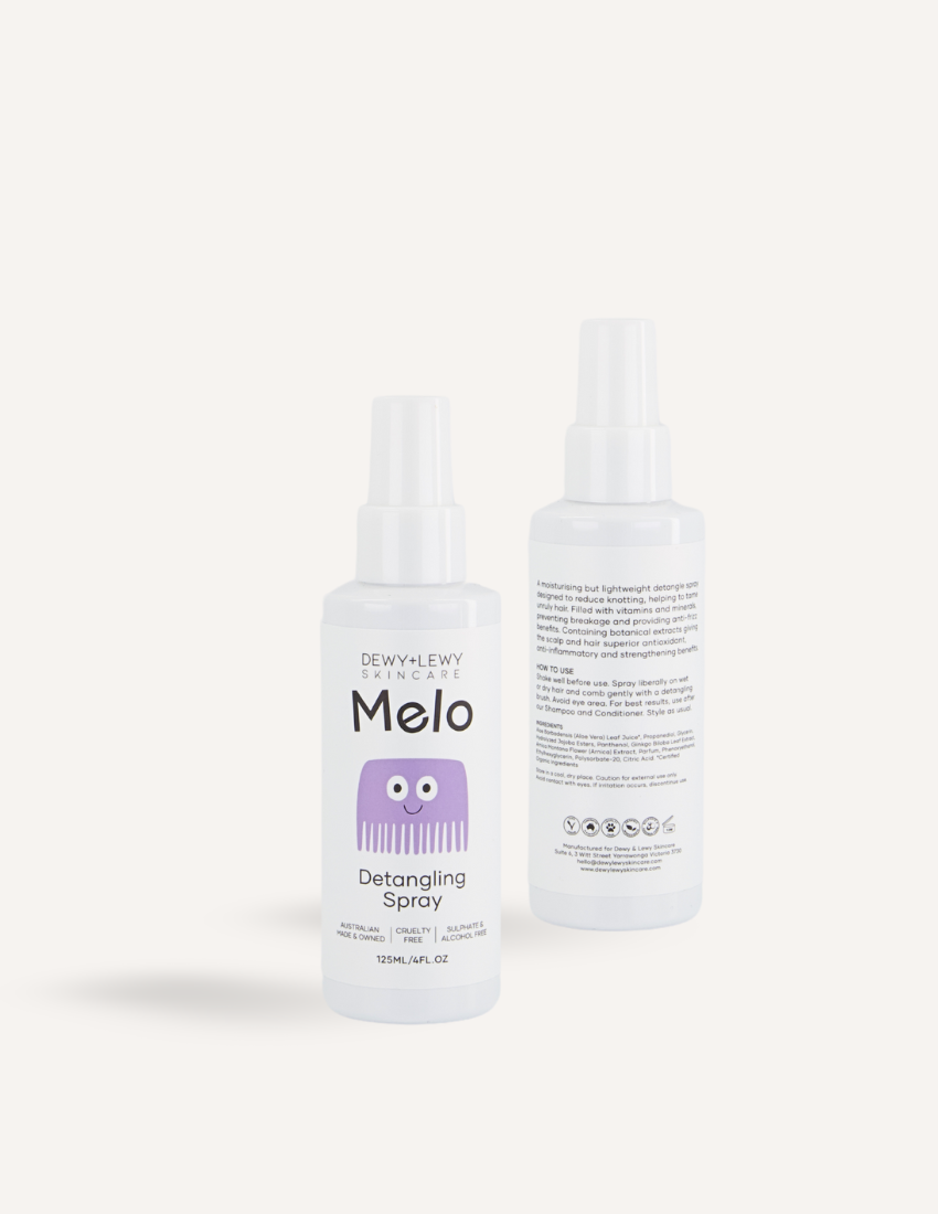 Two white spray bottles with purple labels of Melo Detangling Spray by Melo, each containing 135ml (4.6oz). The front bottle displays the product name along with an illustration of a purple comb, while the back bottle provides usage instructions, ingredients, and emphasizes its cruelty-free organic formula designed for children's hair care.