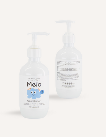 Two bottles of Melo's Melo Conditioner are displayed. One bottle faces forward, showcasing the product label, while the other faces backward, displaying the ingredient list and information. Both bottles, designed for babies with a gentle formula, feature white pumps and are paraben-free.