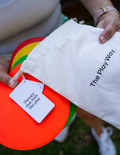 A stack of The Play Way Spot Markers in various colors, including red, yellow, green, and orange, arranged in a slightly fanned-out manner on a plain background.