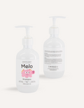 Two white pump bottles of Melo Shampoo by Melo are shown. The front of one bottle features a smiling pink character and the text “Melo Shampoo,” while the back of the other bottle displays ingredients and usage instructions in black text. This gentle, cruelty-free shampoo is perfect for sensitive scalps.