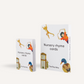 The "Nursery Rhyme Card Set" by The Play Way consists of two boxes that enhance early childhood language skills. The smaller box on the left displays images of animals and a clock, while the larger one on the right highlights a dancing figure and a duck. Both boxes are white with vibrant graphics.
