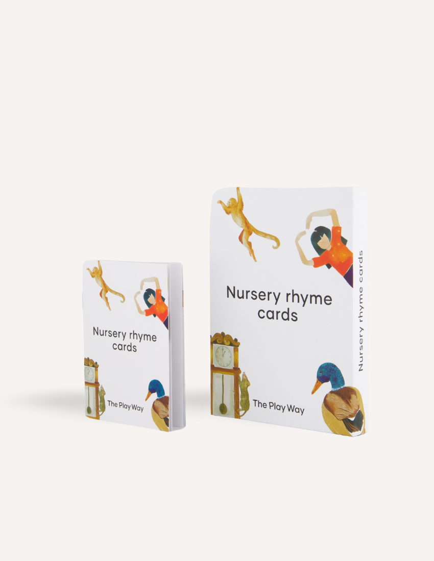 The "Nursery Rhyme Card Set" by The Play Way consists of two boxes that enhance early childhood language skills. The smaller box on the left displays images of animals and a clock, while the larger one on the right highlights a dancing figure and a duck. Both boxes are white with vibrant graphics.