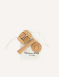 A set of three Wooden Fidgets by Sensory Play Australia is displayed on a white background. The fidgets include a grooved roller, a ring, and a geometric puzzle designed for tactile play and sensory regulation. They are placed on a white drawstring bag labeled 