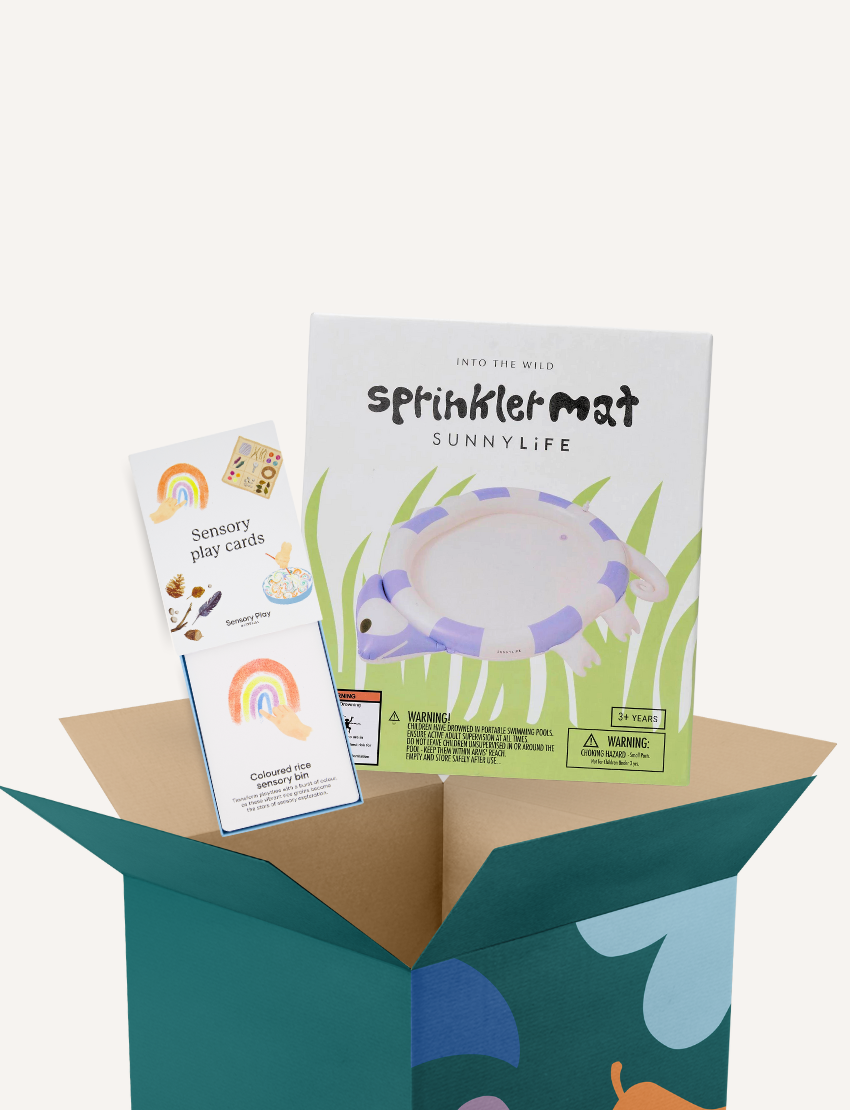 The Play Way Sensory Regulation Kit box is open, showing a SunnyLife Sprinkler Mat and colorful Sensory Play Cards.