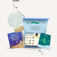 The Sleep Buddy by Sensory Play Australia is a delightful sleep-themed gift box featuring the children's book "Finley's Night-time Journey," a soothing bedtime routine board game, a comforting "Sweet Dreams" night light, and an informative booklet titled "Sleep." These items are elegantly organized in an open teal box to create the ideal sleep companion for your little one.
