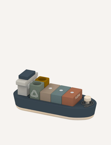 The Wooden Container Ship by Flexa is a beautifully crafted toy featuring an array of colorful block shapes stacked on its deck. Its smooth, minimalist design includes a small smokestack and several rectangular blocks, with a dark blue hull complemented by natural wood accents.