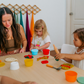 Children and an adult engage in playdough activities from The Play Way Fine Motor Foundations Program for OT at home.