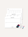 The Play Way's Magnetic Planner Kit features an open box filled with organizational materials, including a weekly planner, a daily planner, and a sheet of various colorful stickers depicting everyday activities and objects. Also included are multiple markers in different colors.