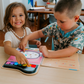 Two children engage with an interactive book from The Play Way Fine Motor Foundations Program, fostering OT at home fine motor skills and development.