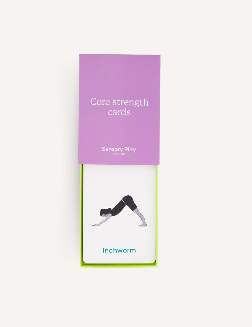 A green box is open, revealing a yellow scooter board, a silver exercise ball, and a set of purple and white "Inchworm" Core Strength Cards, all part of The Play Way's ultimate Core Strength Kit.