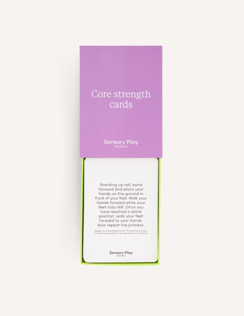 A green box is open, revealing a yellow scooter board, a silver exercise ball, and a set of purple and white "Inchworm" Core Strength Cards, all part of The Play Way's ultimate Core Strength Kit.