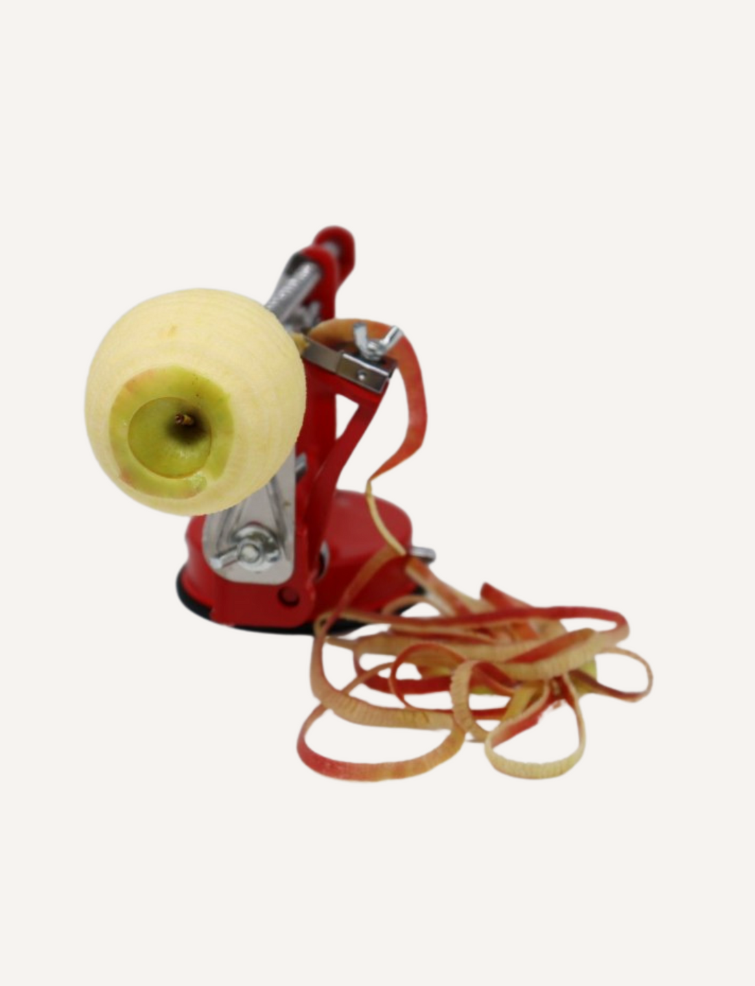 The Core Slice Peel's Apple Slinky, highlighted against a plain white background, features a red design and black handle. This device includes a stainless steel blade, manual crank, and suction base, making it ideal for efficiently peeling, coring, and slicing apples to prepare delicious fruit snacks.