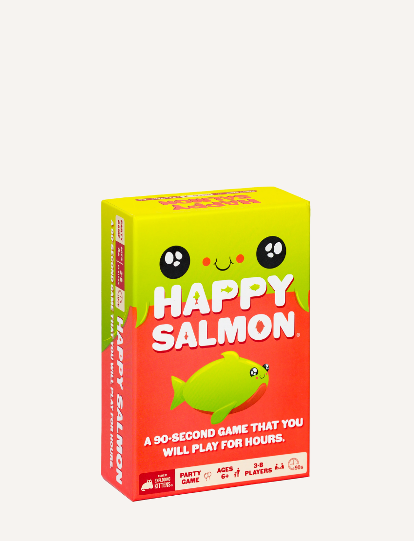 The image displays a package of the "Happy Salmon Game" by Exploding Kittens. The box is green and features a cartoon fish illustration. It declares, "A 90-second game that you will play for hours," and suggests it's a party game suitable for ages 6 and up, accommodating 3 to 6 players.