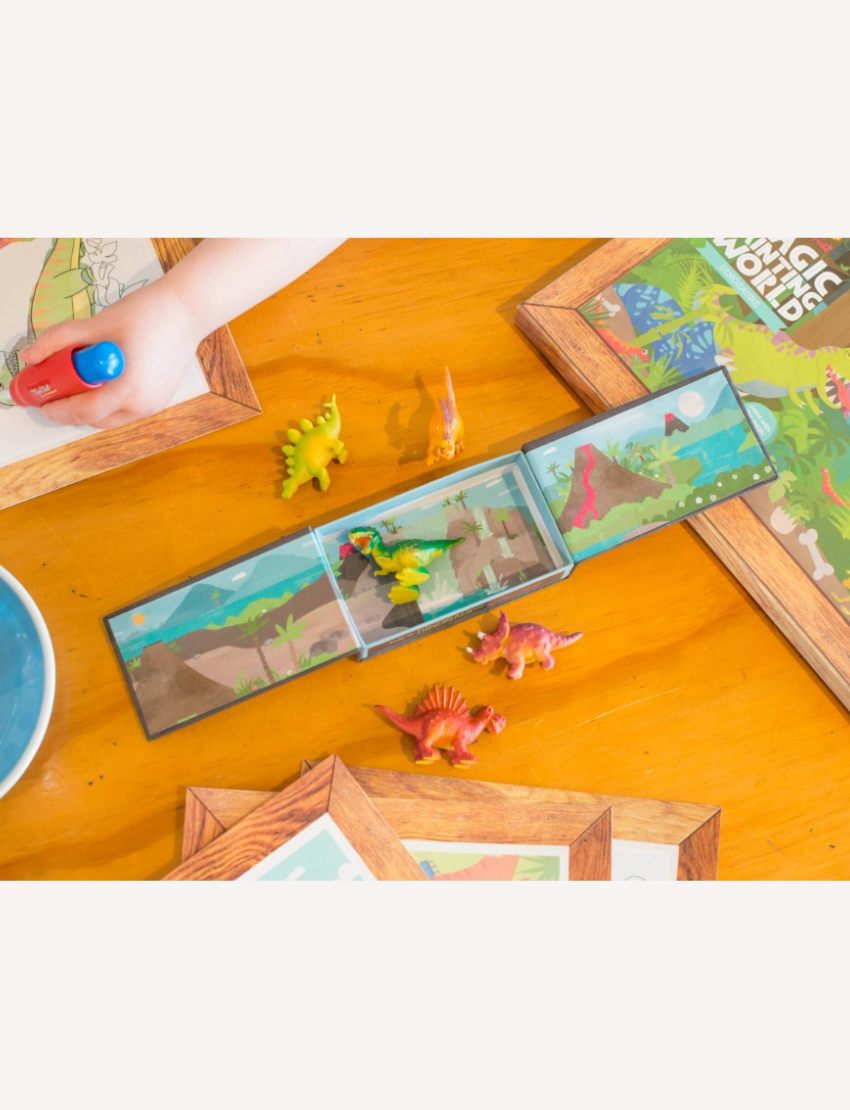 A boxed children's activity set from Tiger Tribe, named Magic Painting World - Dinosaurs, features colorful dinosaur illustrations and includes a magic paintbrush water pen. Recommended for children aged 1 and above, this portable play set boasts packaging with a charming wooden frame design.