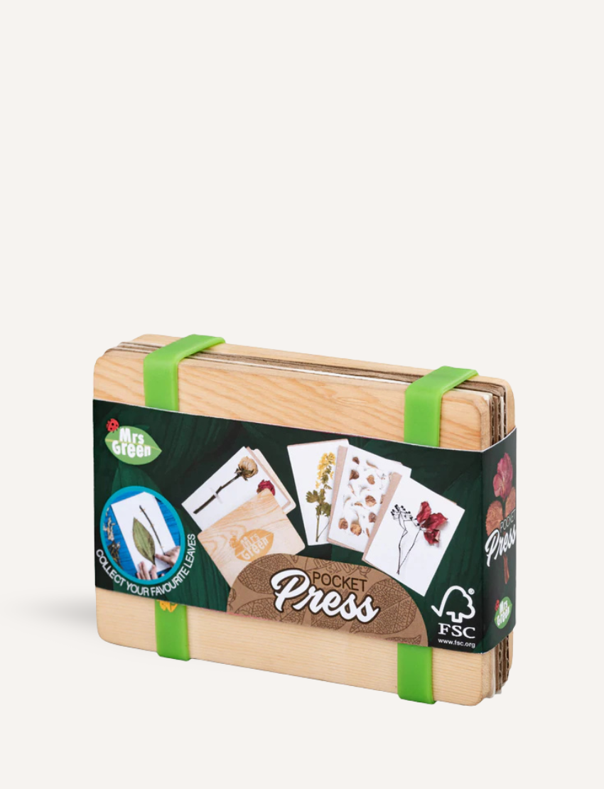 The Flower Press - Small by Mrs Green is a wooden pocket press featuring green straps, specifically designed for pressing plants. The packaging showcases images of pressed flowers and leaves and is labeled as FSC certified, ensuring sustainable wood sourcing.