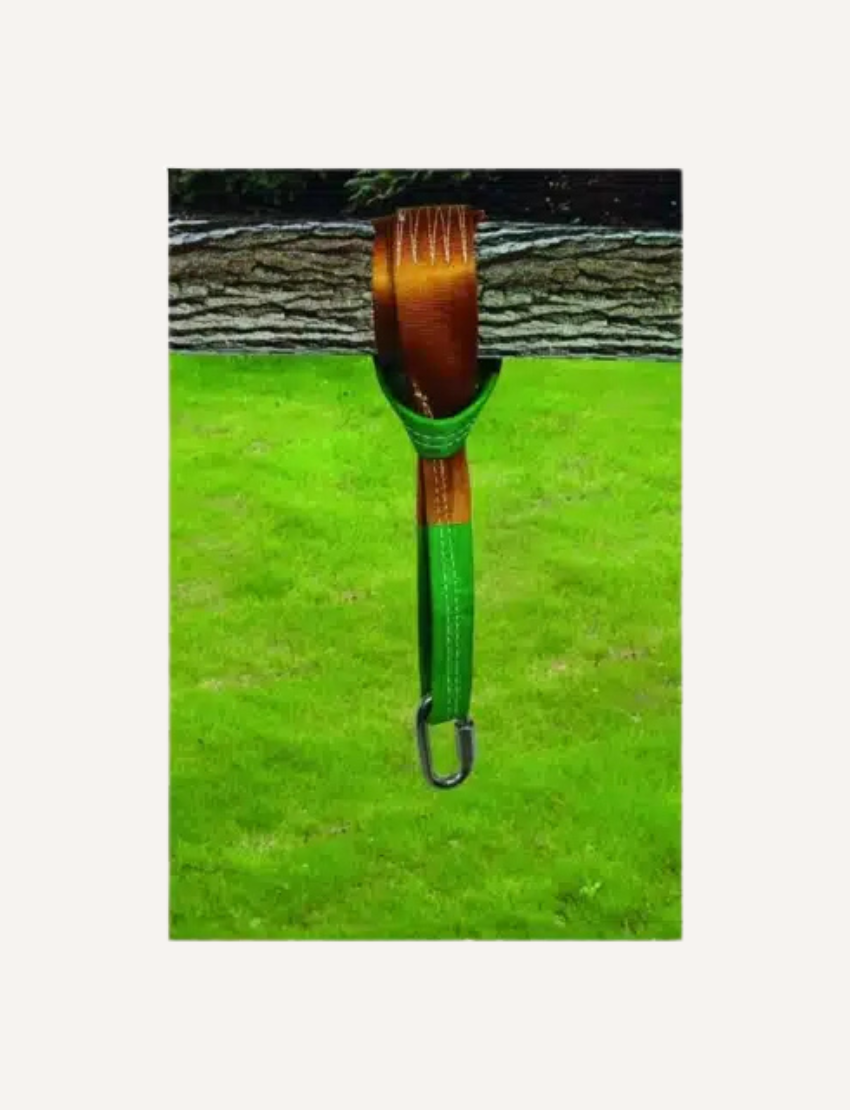 The image displays the 6-foot Tree Hanger by Slackers, with a brown strap, green ends, and a metal buckle. Its packaging, "Sky Tree Hanger," shows it mounted on a tree for backyard fun.