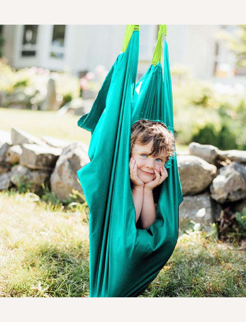 The Slackers Hammock Swing is elegantly displayed with its teal fabric and adjustable ropes. The packaging showcases backyard play and highlights the product as a "Hammock Swing" ideal for outdoor relaxation.