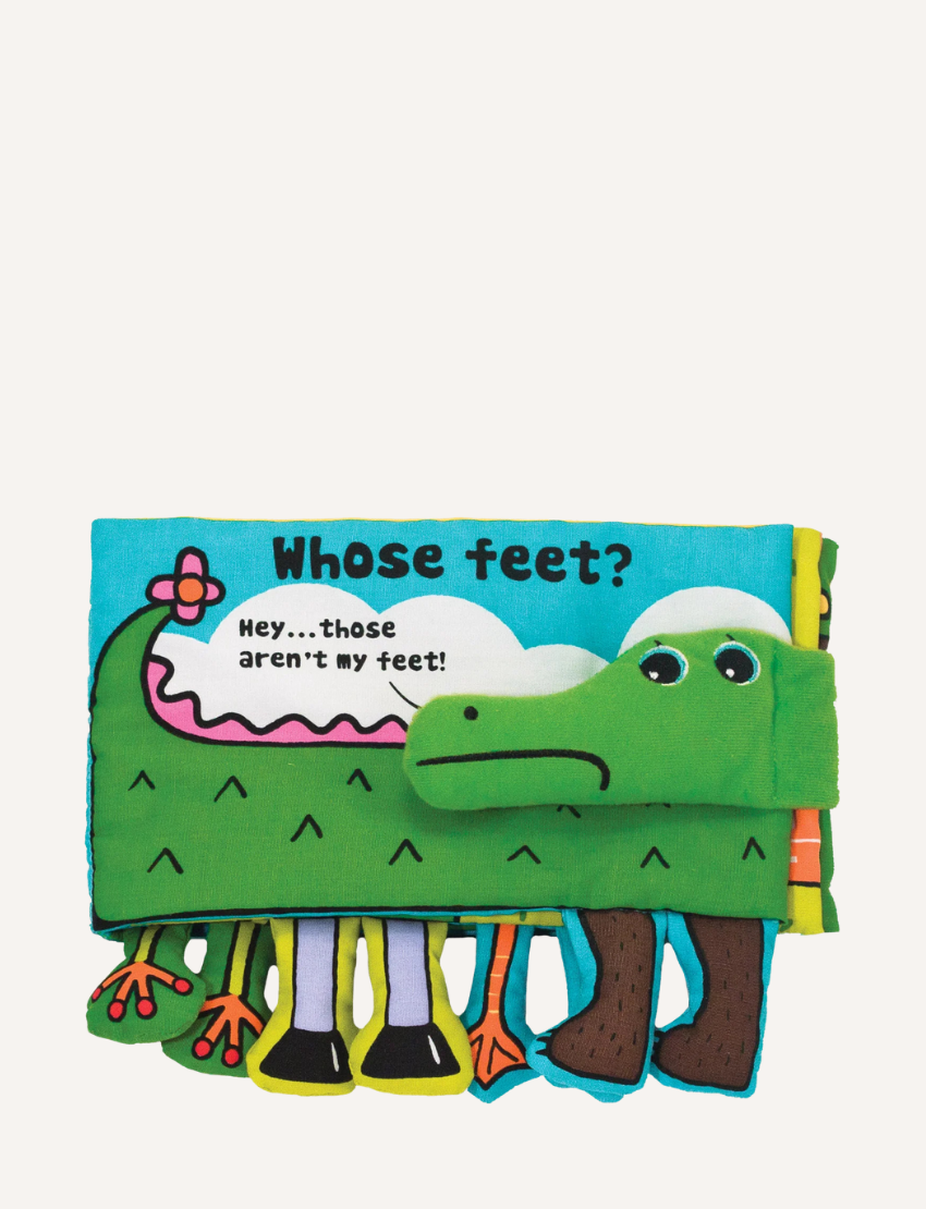 'Whose Feet?' soft book open to reveal a green crocodile character with various animal feet attached.