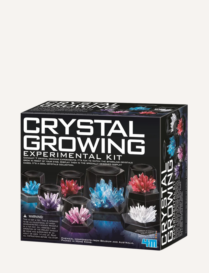 The Crystal Growing Kit (Large) by 4M Toys features an array of crystal clusters in shades of blue, red, white, purple, and pink. These vibrant crystals are beautifully presented in transparent display cases and are set against a dark surface with a matching background.