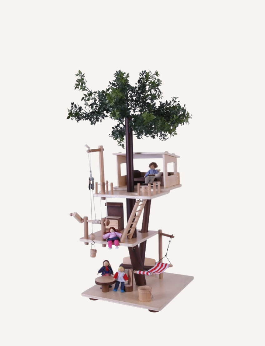 The Ever Earth Tree House is a wooden toy with three levels, featuring miniature furniture, figures, and accessories. It includes a swing on one side and a rope ladder on the opposite side. At the top, there is a small artificial tree surrounded by figures posed in various activities.