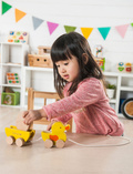 The Play Pull Along Duck & Egg by Ever Earth consists of two interlocking semi-circular pieces. One piece has a yellow disc partially concealed within a slot, while the other piece features a corresponding cut-out to accommodate the disc when assembled. The background is plain white.