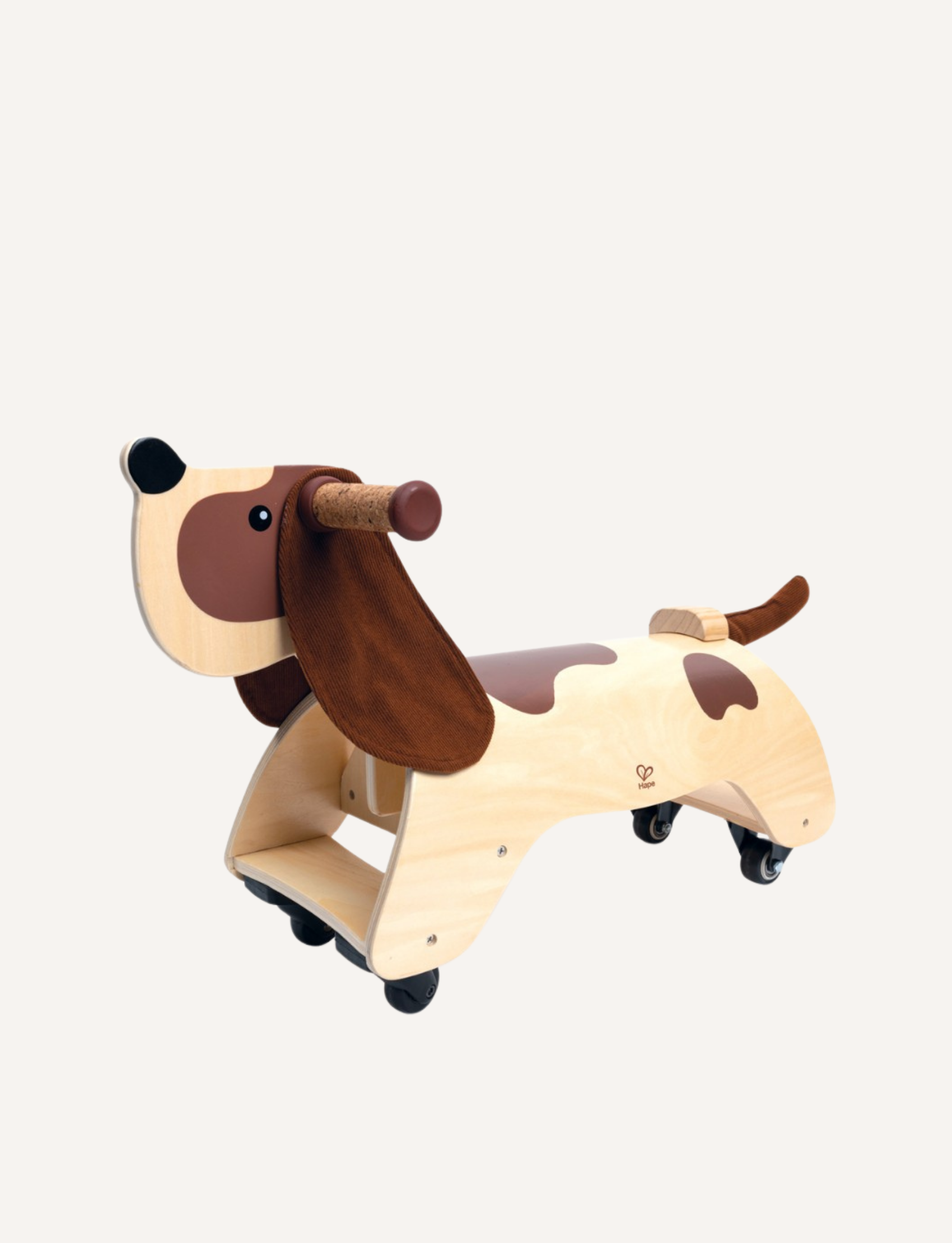 The Hape Dachshund Dog Wooden Ride On is a fun and stylish wooden toddler walker featuring four wheels, a handlebar at the dog's head, an ergonomic seat, brown felt ears, and a tail. The main body is crafted from sturdy wood with light wood shades and darker brown patches mimicking the dog's fur.