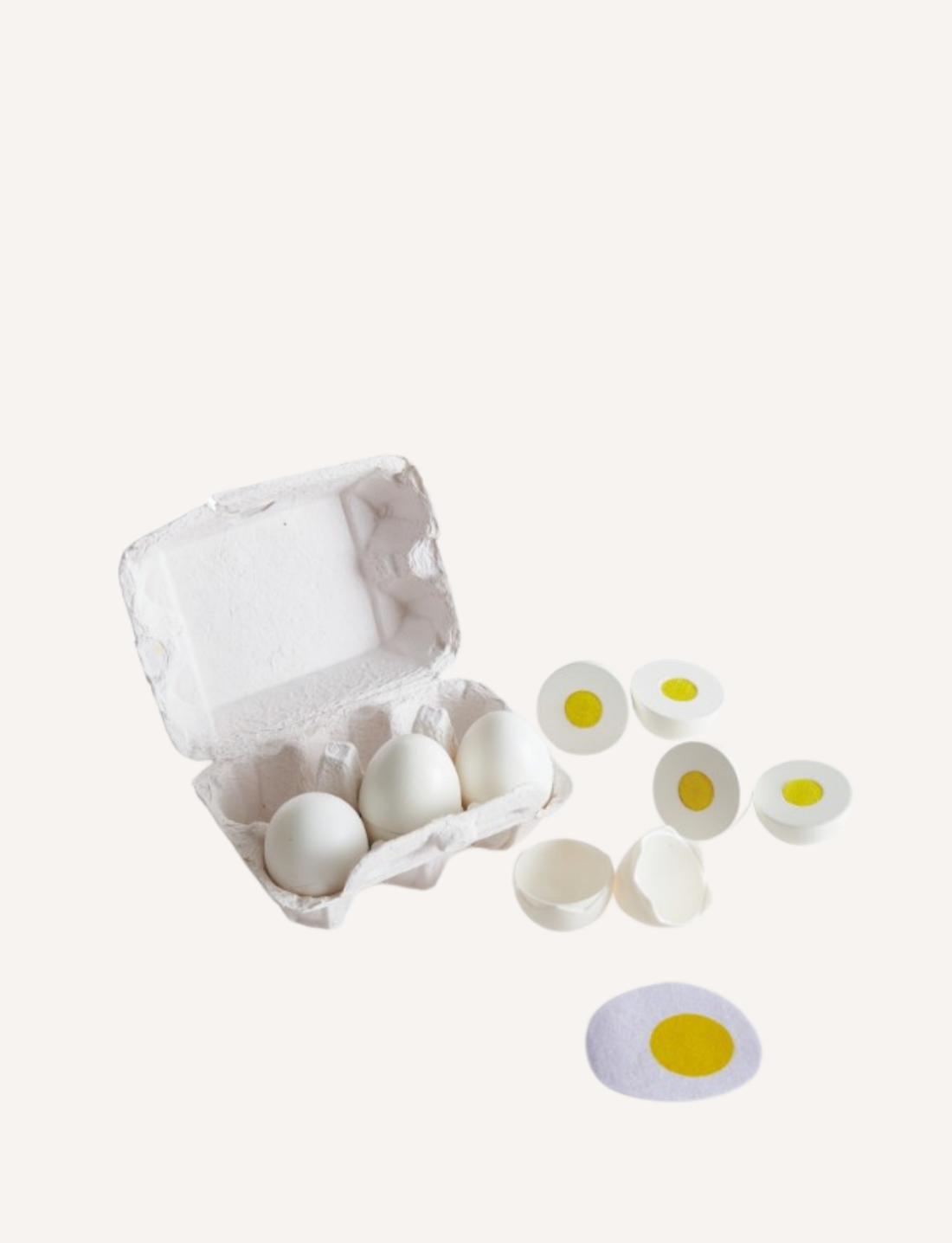 The Hape Egg Carton includes three whole white eggs, several halved eggs with yellow centers, one whole egg with the top removed, two empty shells, and a flat realistic play egg representation with a yellow center—making it an ideal addition to any kids' cooking set.