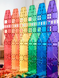 A box of the Connetix Tiles 212-Piece Magnetic Tile Mega Pack features red packaging adorned with images of vibrant geometric shapes creating a rainbow structure. The text states 