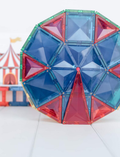 A box of the Connetix Tiles 212-Piece Magnetic Tile Mega Pack features red packaging adorned with images of vibrant geometric shapes creating a rainbow structure. The text states 