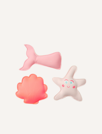 The Melody the Mermaid Dive Buddies Neon Strawberry Set of 3 by Sunnylife features three adorable plush toys on a white background, including a pink mermaid tail, an orange shell, and a white starfish with a smiley face and blue eyes—ideal companions for children's water play.