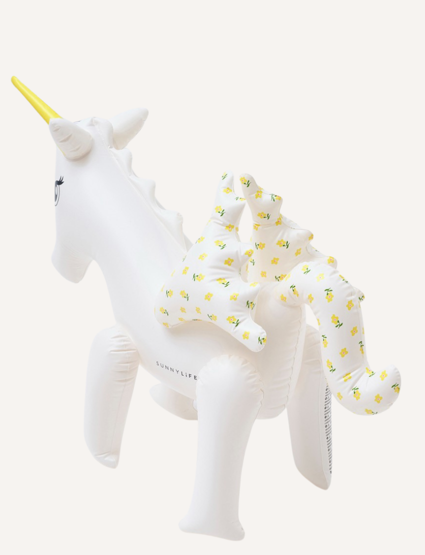 The Sunnylife Inflatable Sprinkler, named Mima the Unicorn - Lemon Lilac, is designed as a white unicorn with a yellow horn. Crafted from non-toxic PVC, this enchanting float features flower-patterned wings and a detailed eye on its head, making it both safe and captivating.