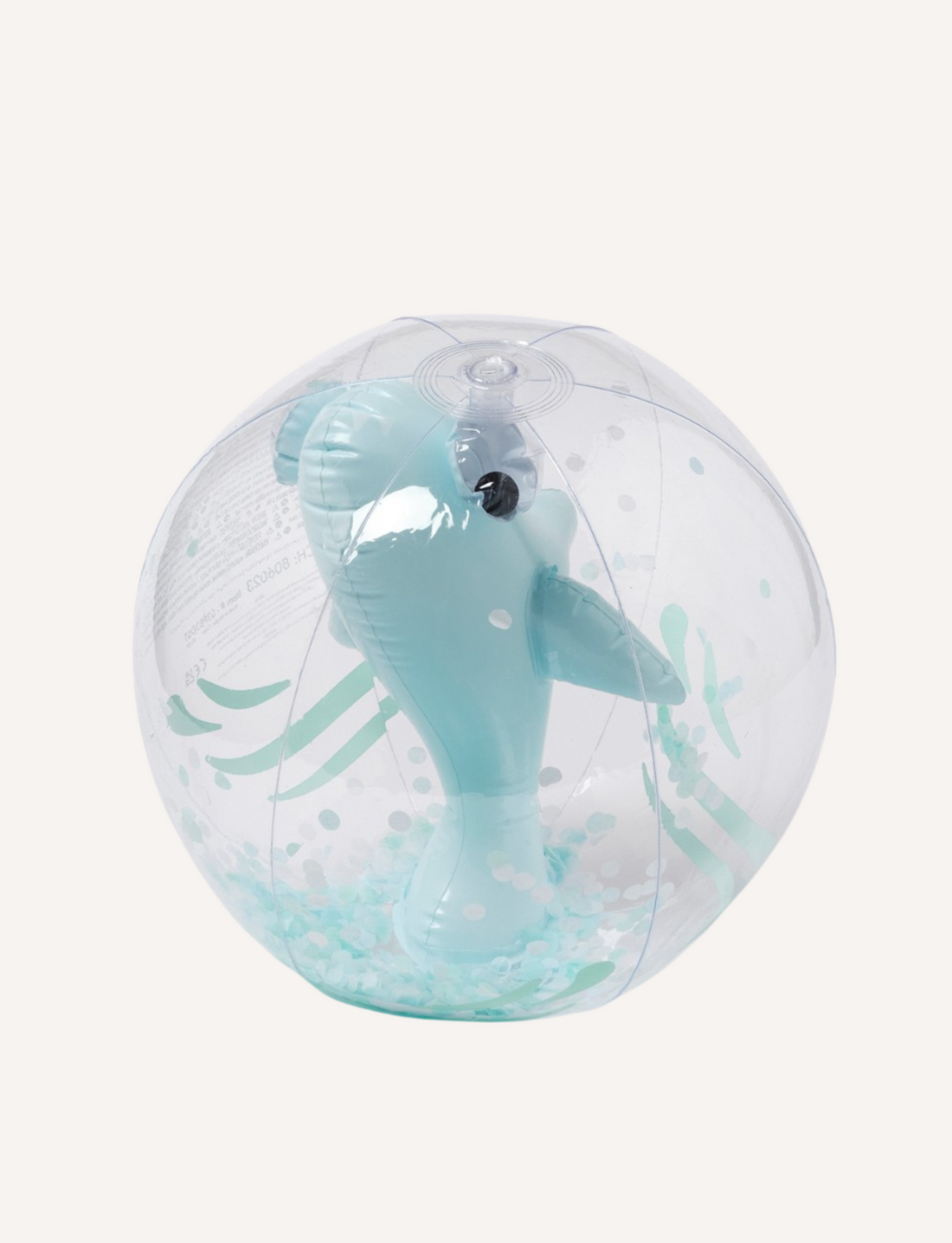 The 3D Inflatable Beach Ball Shark Tribe Khaki by Sunnylife is a fully inflated, transparent beach ball featuring small teal polka dots and a teal dolphin-shaped balloon at its center. This durable beach ball is crafted from Phthalate-free PVC material.