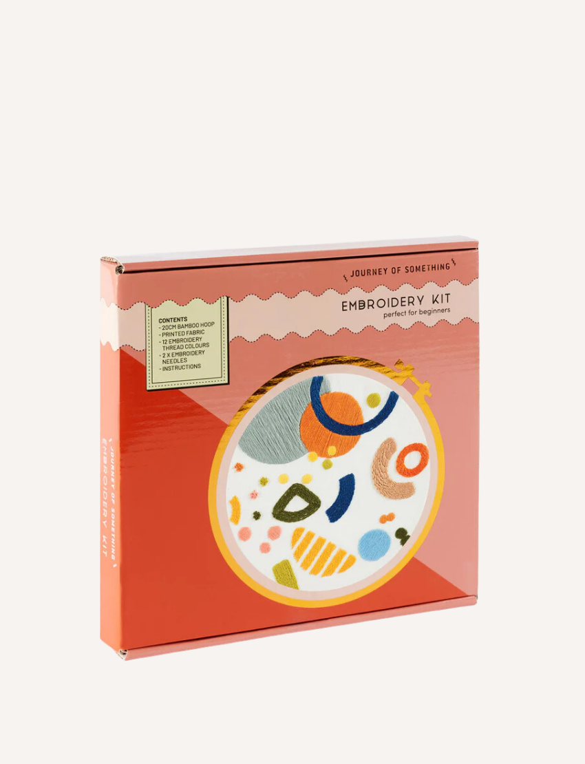 The "Journey of Something" Embroidery Kit includes a bamboo hoop and features vibrant red, pink, and blue floral patterns on the packaging. A sticker indicates its suitability for beginners, offering an easy entry into crafting.