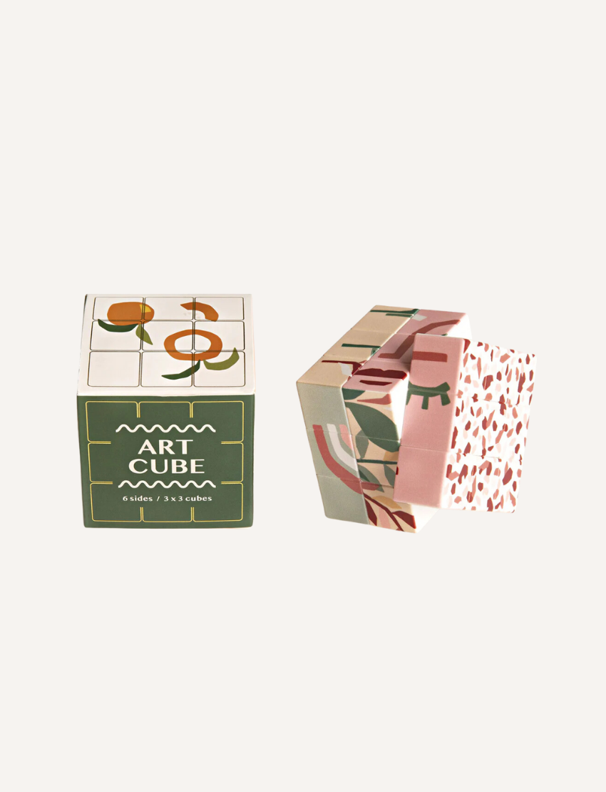 The Art Cube - Valencia by Journey of Something floats against a plain background, showcasing modern abstract patterns in orange, white, and pink with one side featuring small floral motifs.