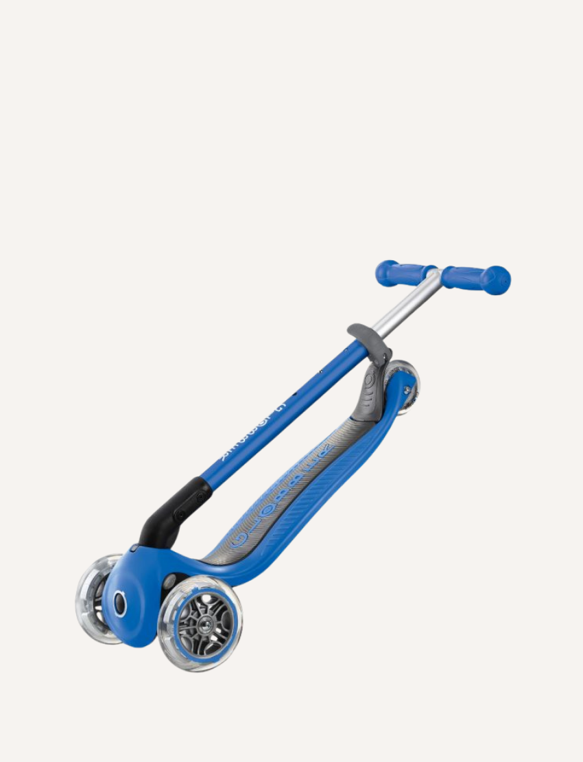 A PRIMO Foldable Scooter - Navy Blue by Globber for children, featuring a T-shaped handlebar, a wide deck with a textured grip, and two larger front LED wheels alongside one smaller rear wheel. The handlebar grip and wheels are blue, matching the color of the scooter.